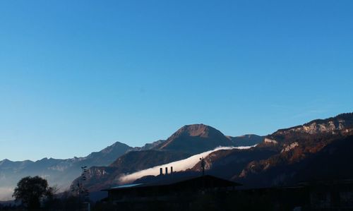 Scenic view of mountains against clear blue sky