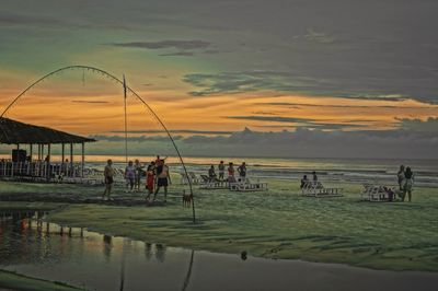 People on beach at sunset