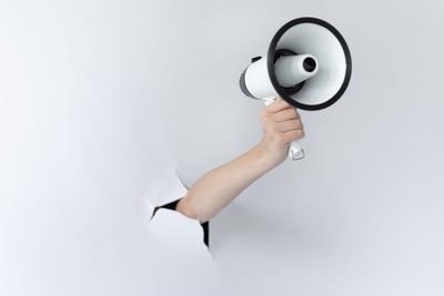 Low angle view of person holding hands against white background