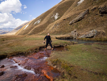 Rear view of man walking on mountain