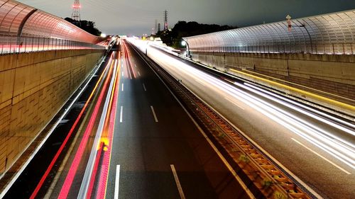 Light trails on railroad tracks in city