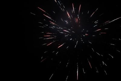 Low angle view of firework display at night