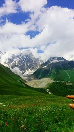 Scenic view of mountains against cloudy sky