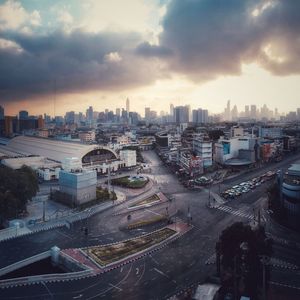 High angle view of city street against cloudy sky