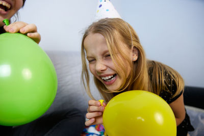 Portrait of young woman with balloons