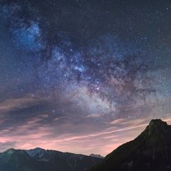 Scenic view of landscape against sky at night