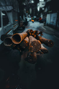 Close-up of rusty metal on street in city at night