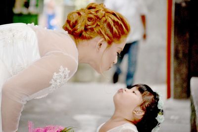 Beautiful bride playing with cute bridesmaid