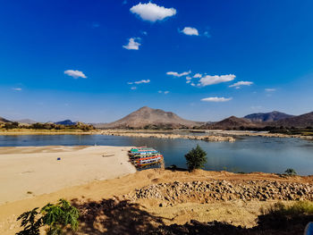 Scenic view of lake against blue sky
