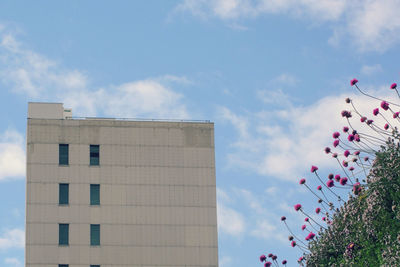 Low angle view of building against cloudy sky