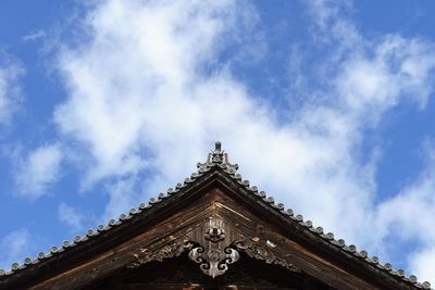 Low angle view of temple against cloudy sky