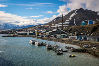 Scenic view of buildings and mountains against sky