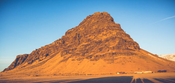 Scenic view of mountain against clear blue sky