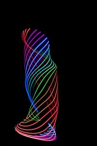 Close-up of light trails over black background