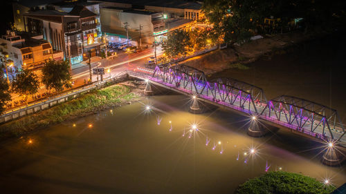 High angle view of illuminated bridge over canal at night