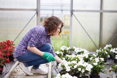 Smiling woman working in botanical garden