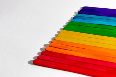 Close-up of colored pencils over white background