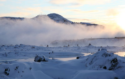 Scenic view of snow covered mountains against sky during sunset