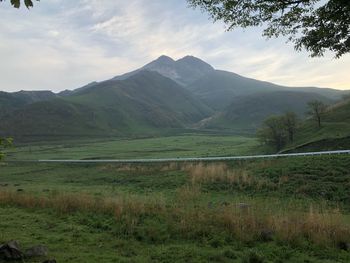 Scenic view of landscape and mountains against sky