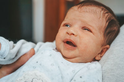 Midsection of parent holding baby