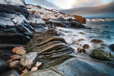 Waves splashing on rocks at beach