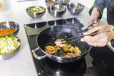 Midsection of man preparing food in kitchen at home