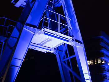 Low angle view of illuminated bridge at night