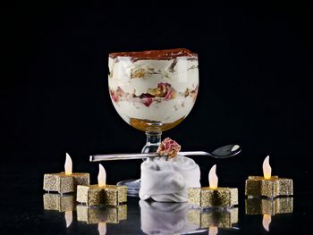 Close-up of cake on table against black background