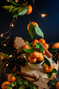 Close-up of fruits and leaves on table