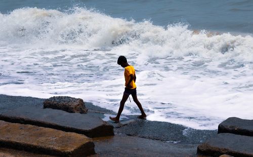 Full length of man standing on beach