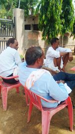 Rear view of people sitting on chair