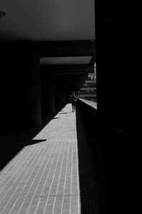 Rear view of person walking on staircase in building