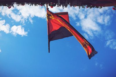 Low angle view of american flag against blue sky