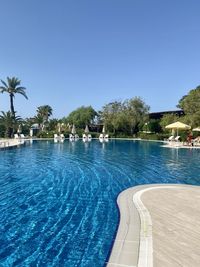 View of swimming pool against clear blue sky