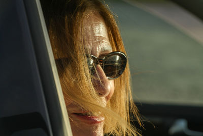 Close-up of young woman in car