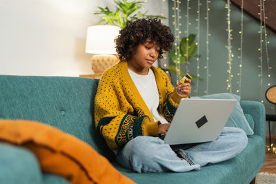 Young woman using laptop at home