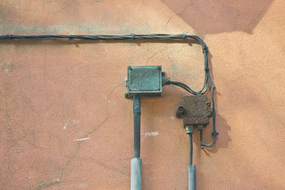 Low angle view of pipe on wall