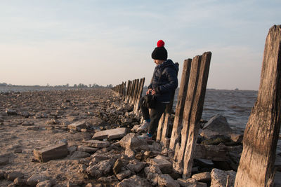 Child hiking near the sea with winter clothing