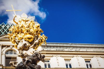 Low angle view of statue against blue sky