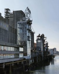 Buildings in city against clear sky