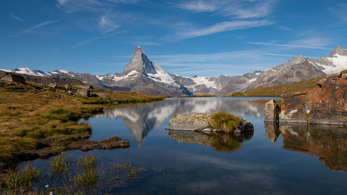 Scenic view of lake and mountains against sky