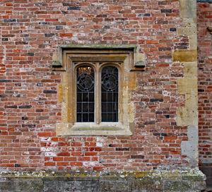 Full frame shot of brick wall with building