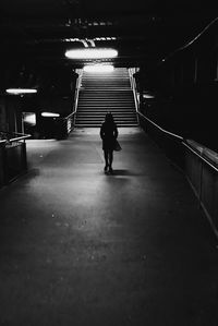 Rear view of silhouette man walking in subway