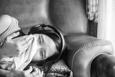 Portrait of woman relaxing on sofa at home