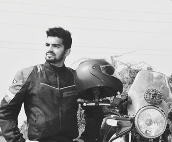 Portrait of young man with car