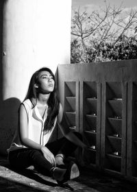 Young woman sitting outdoors