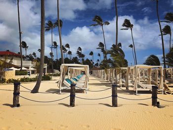 Chairs on beach against sky
