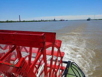 Red structure in sea against clear sky