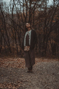 Full length of man standing in forest