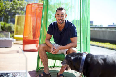 A man sitting in a colorful modern chair.